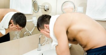 guy washing face and beard