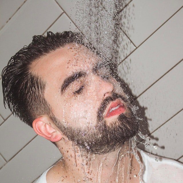 man with beard in shower