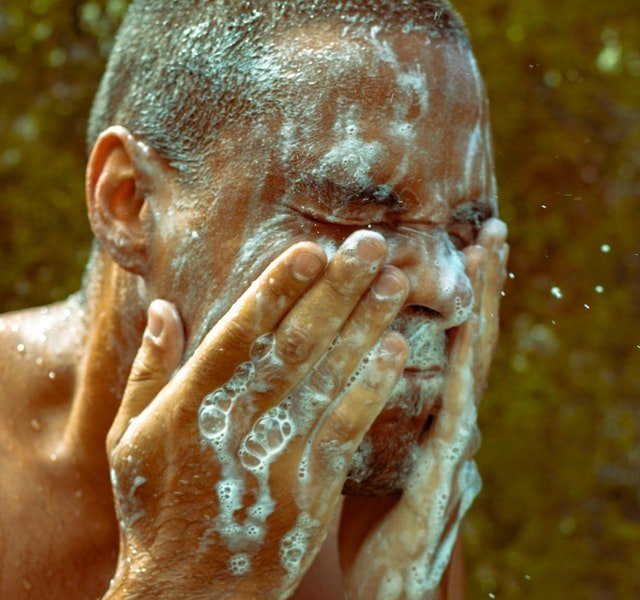 man washing beard