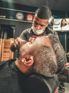 stylist trimming beard